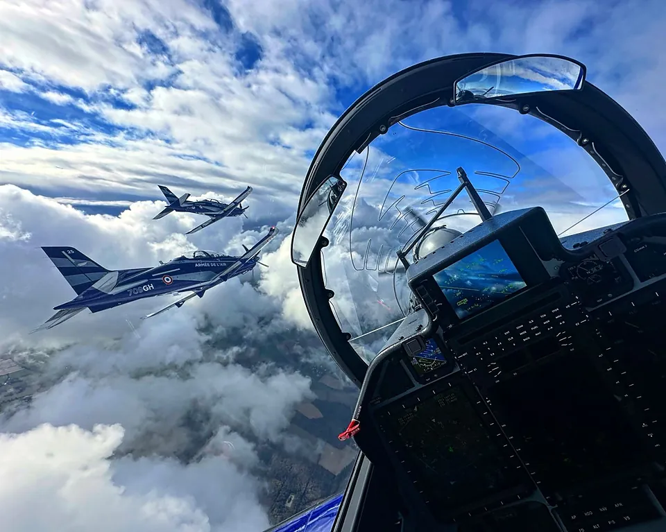 Close-up of the Airparts mirror on the canopy bow, reflecting a formation of aircraft.