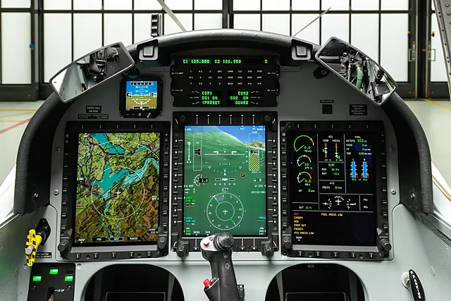 PC-7 MkX glass cockpit instrument panel, showing the canopy bow above.
